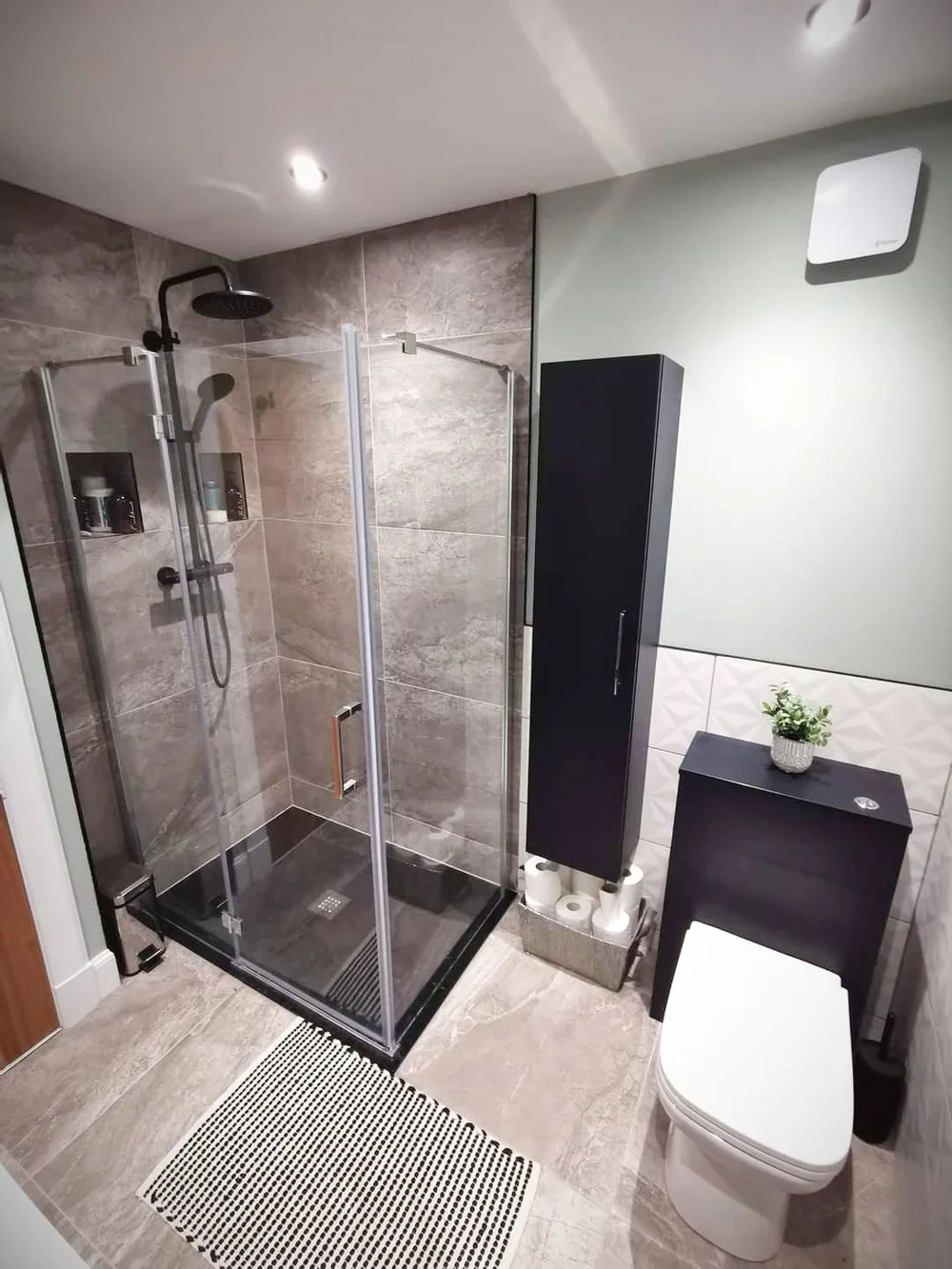 Finished bathroom with shower enclosure and vanity unit